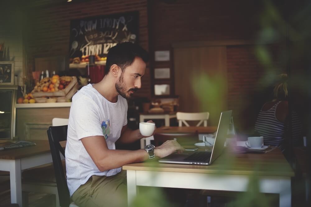 Person Working Remotely in Cafe