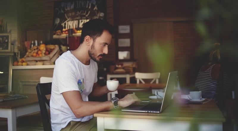 Person Working Remotely in Cafe